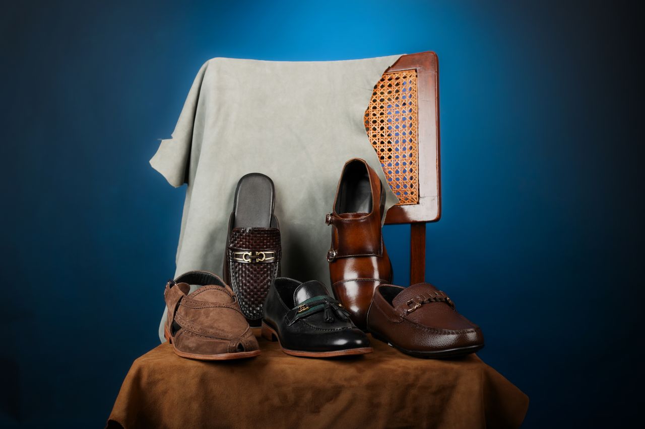 why-choose-us Stylish collection of men's leather dress shoes on a chair, perfect for fashion and formal occasions.
