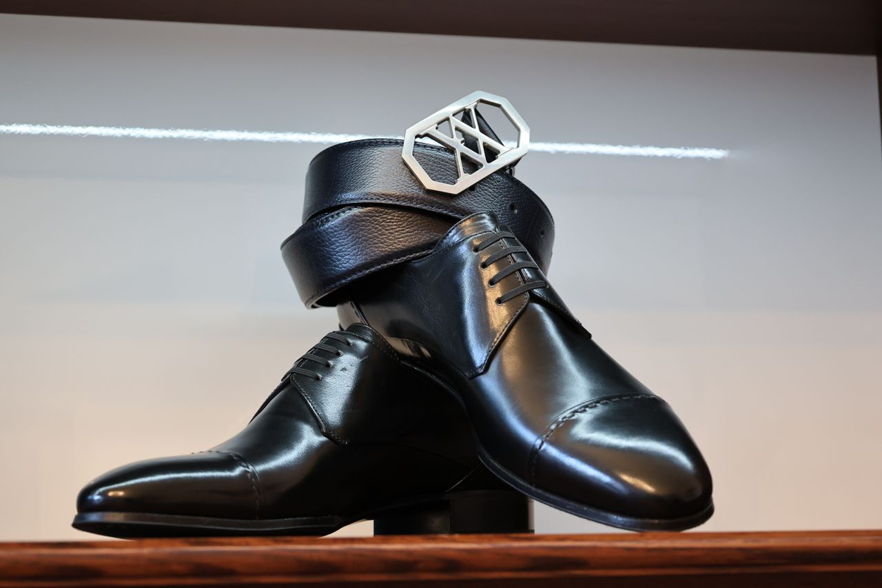 services-04 Classic black leather shoes paired with a matching belt in a stylish arrangement.